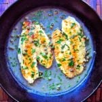 Tilapia piccata in a cast iron skillet