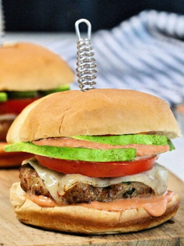 Turkey burgers with cheese, tomato and avocado.
