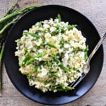 lemon risotto on black plate overhead