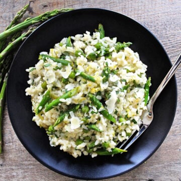 lemon risotto on black plate overhead