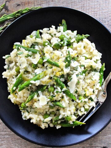 lemon risotto on black plate overhead
