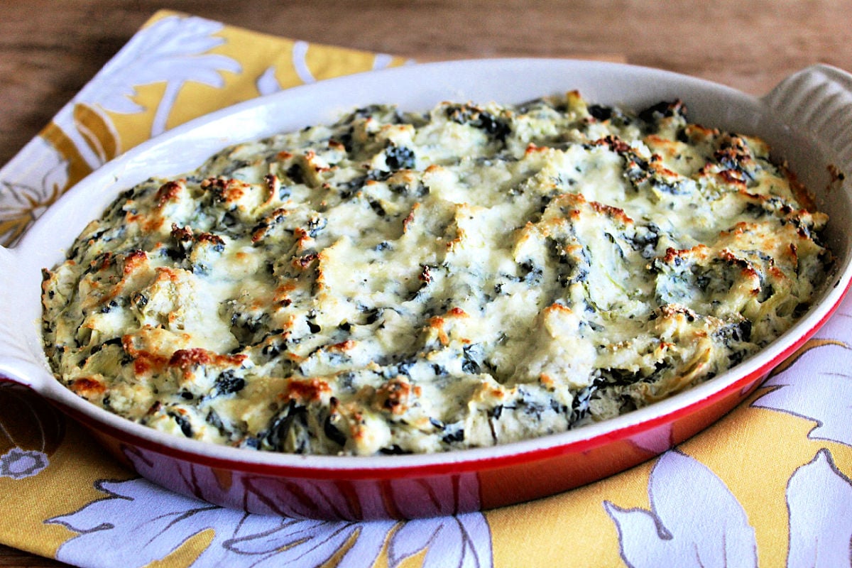 Healthy spinach artichoke dip in red casserole dish