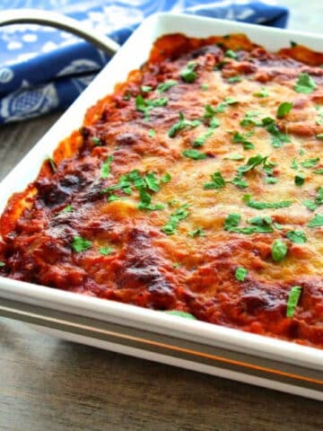 Spaghetti squash lasagna casserole in white baking dish.