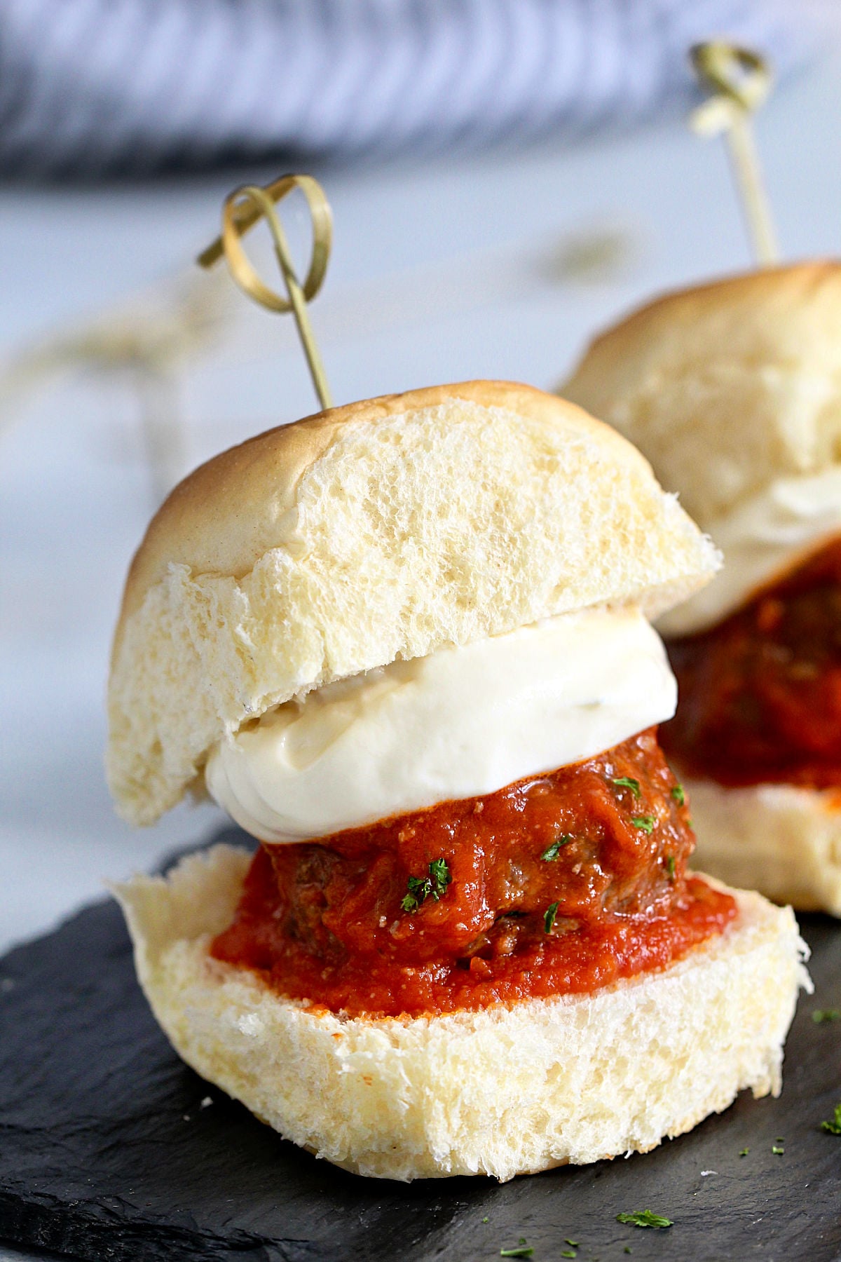 Close up a meatball slider with whipped ricotta