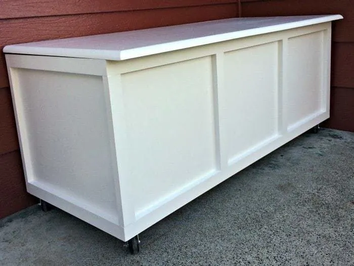 The door hinges in the back of this DIY storage bench raise the lid slightly, which allows water to run off instead of pooling on top