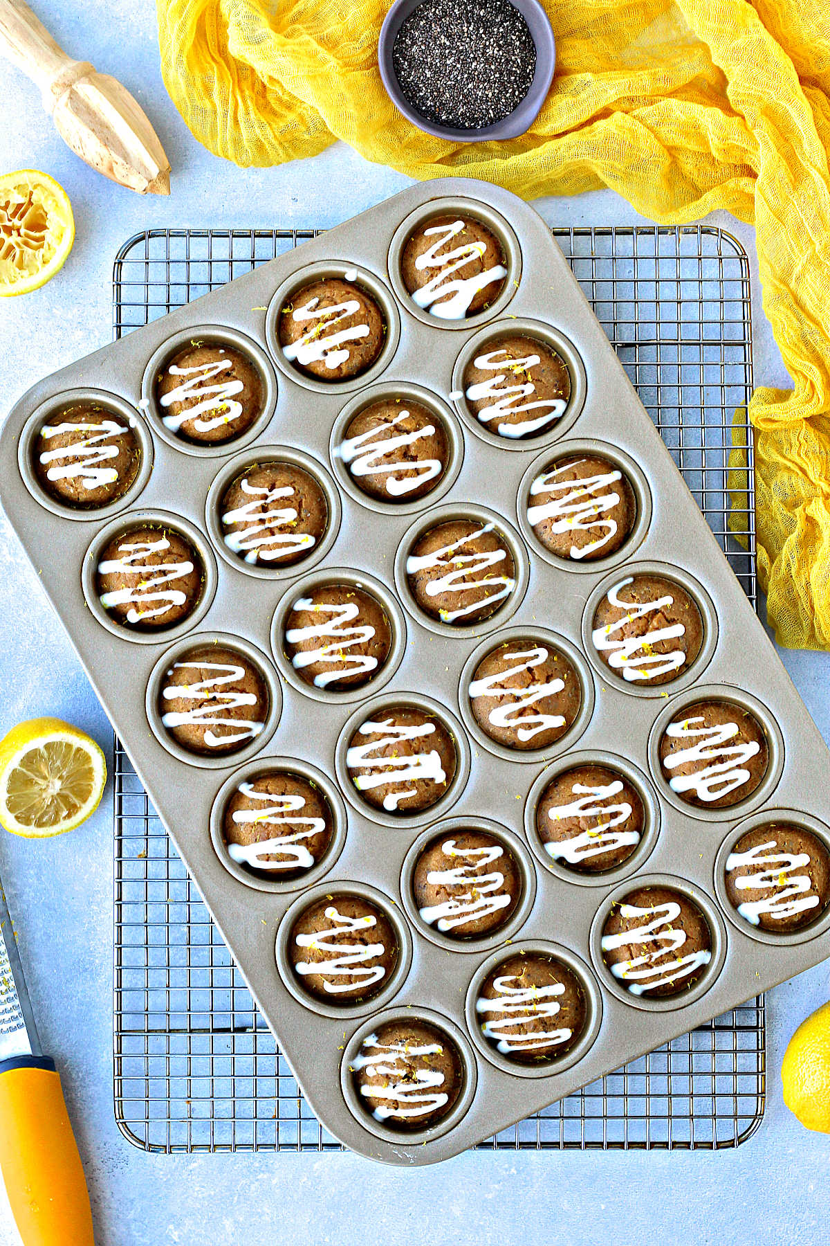 Lemon chia muffins in muffin pan on a baking rack