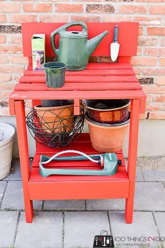red DIY potting bench made from pallets