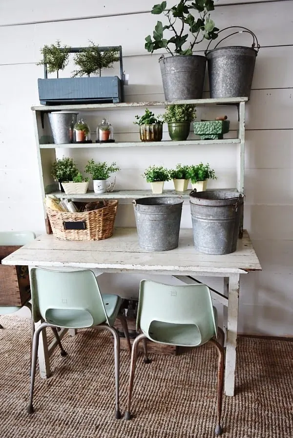 DIY potting bench made from old table and shelving unit.