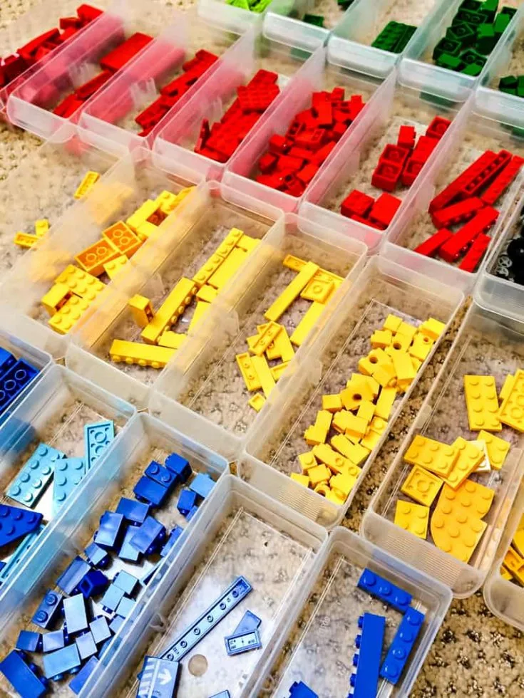 Lego pieces sorted by color in small plastic bins