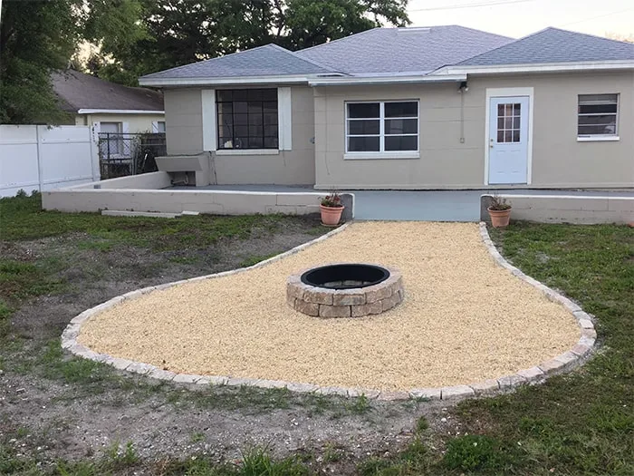 round pea gravel patio with concrete paver fire pit