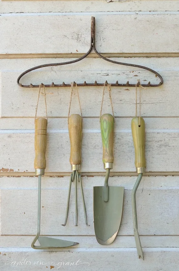 repurposed rake used for garden tool organizer