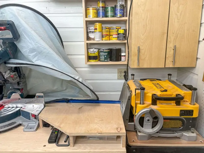 corner of workshop with cabinets, planer and miter saw stand
