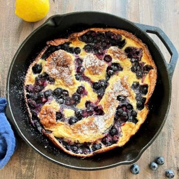 Blueberry lemon dutch baby in a cast iron skillet.