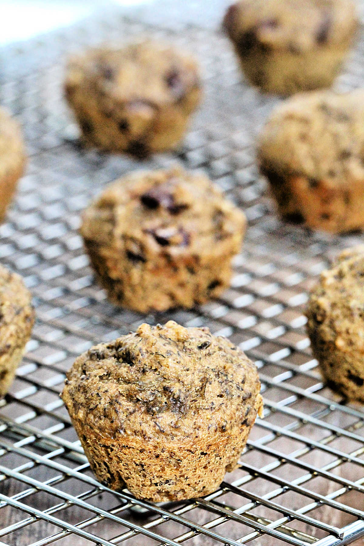 Banana date muffins on a wire rack.