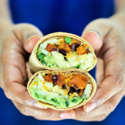 holding burrito cut in half
