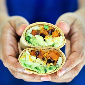 holding burrito cut in half