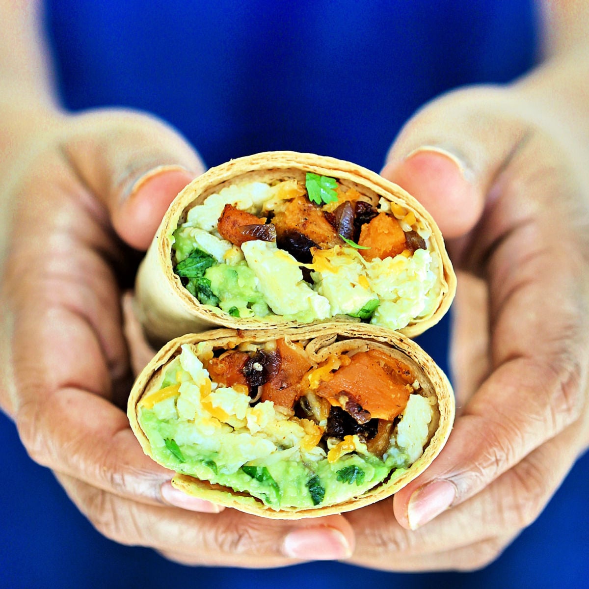 breakfast burrito being held.