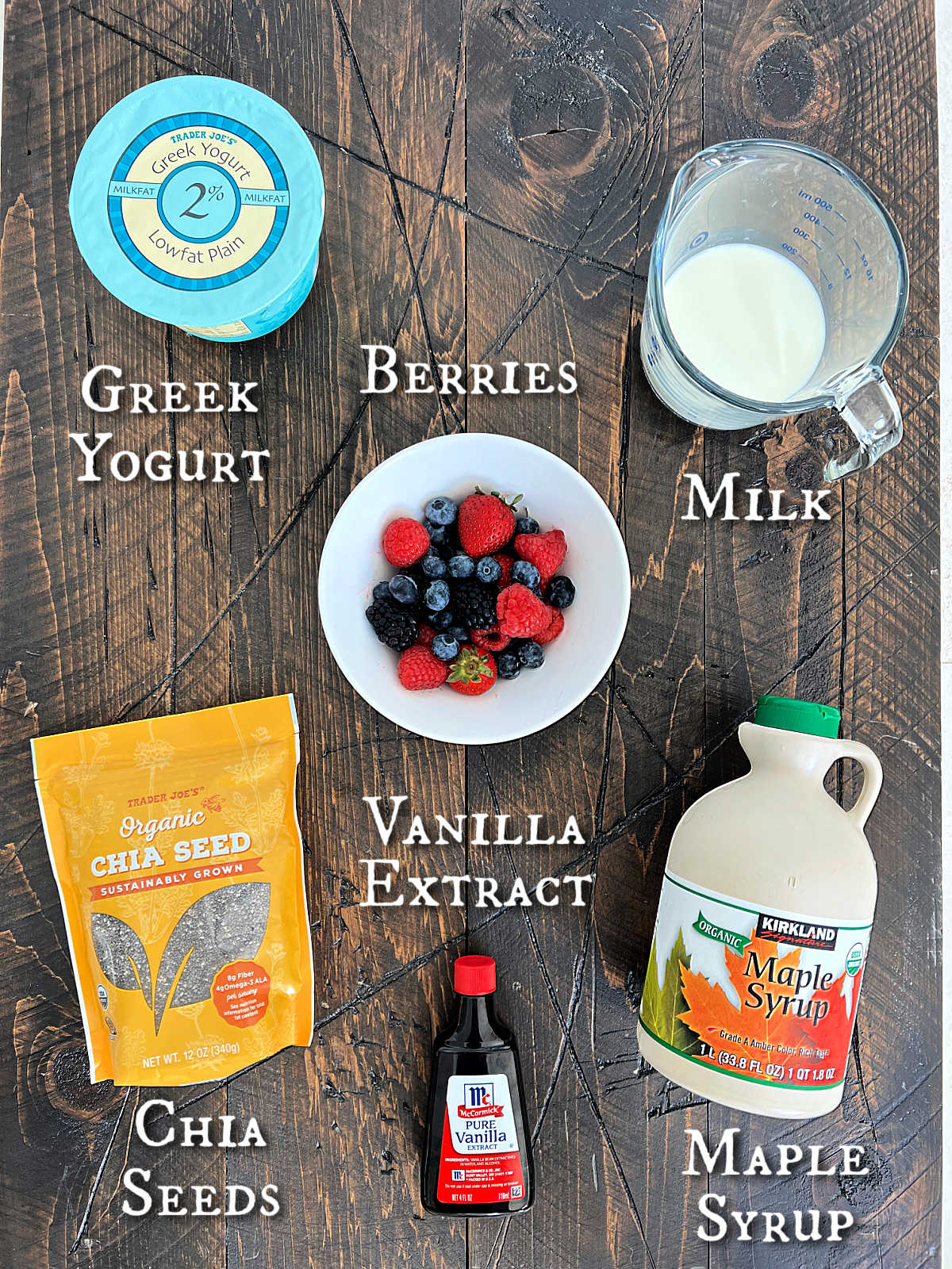 Ingredients for berry chia pudding on a wooden board.
