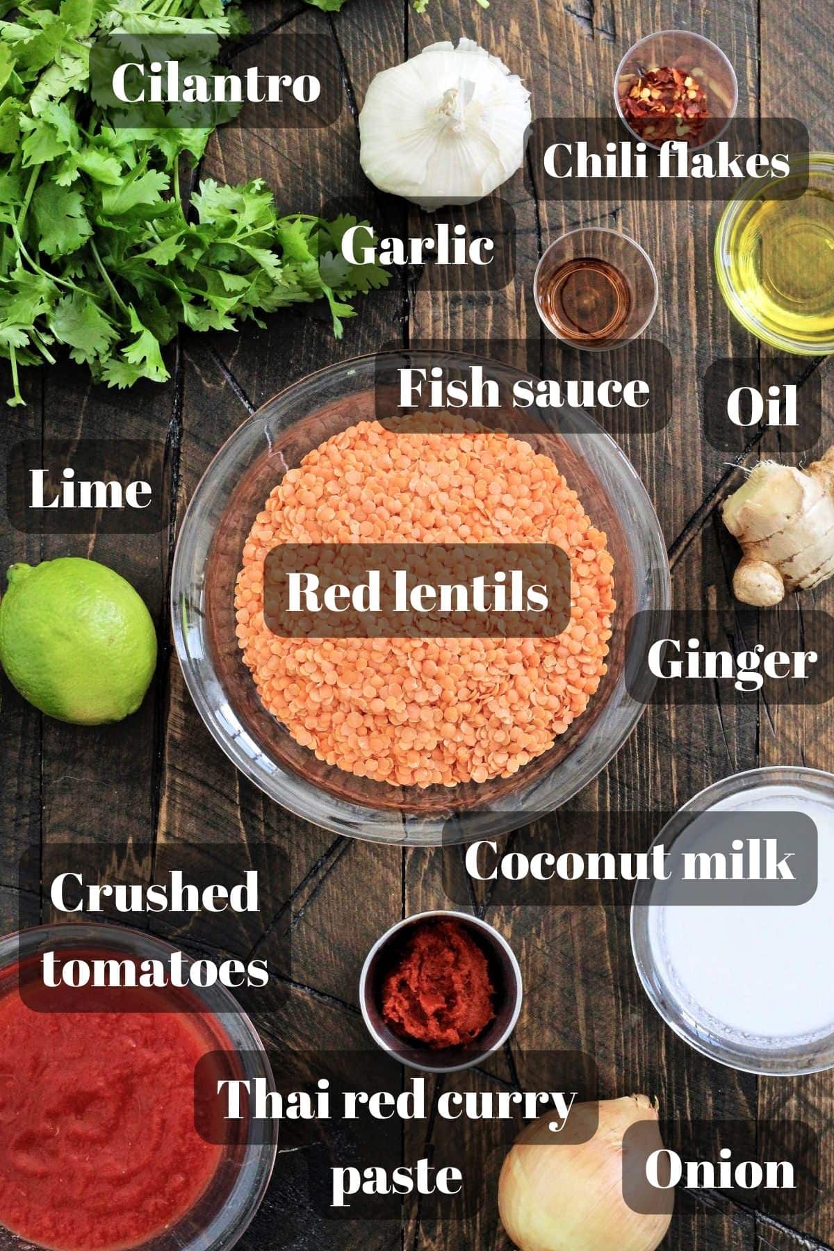 Ingredients for coconut curry lentil soup on a wooden board.
