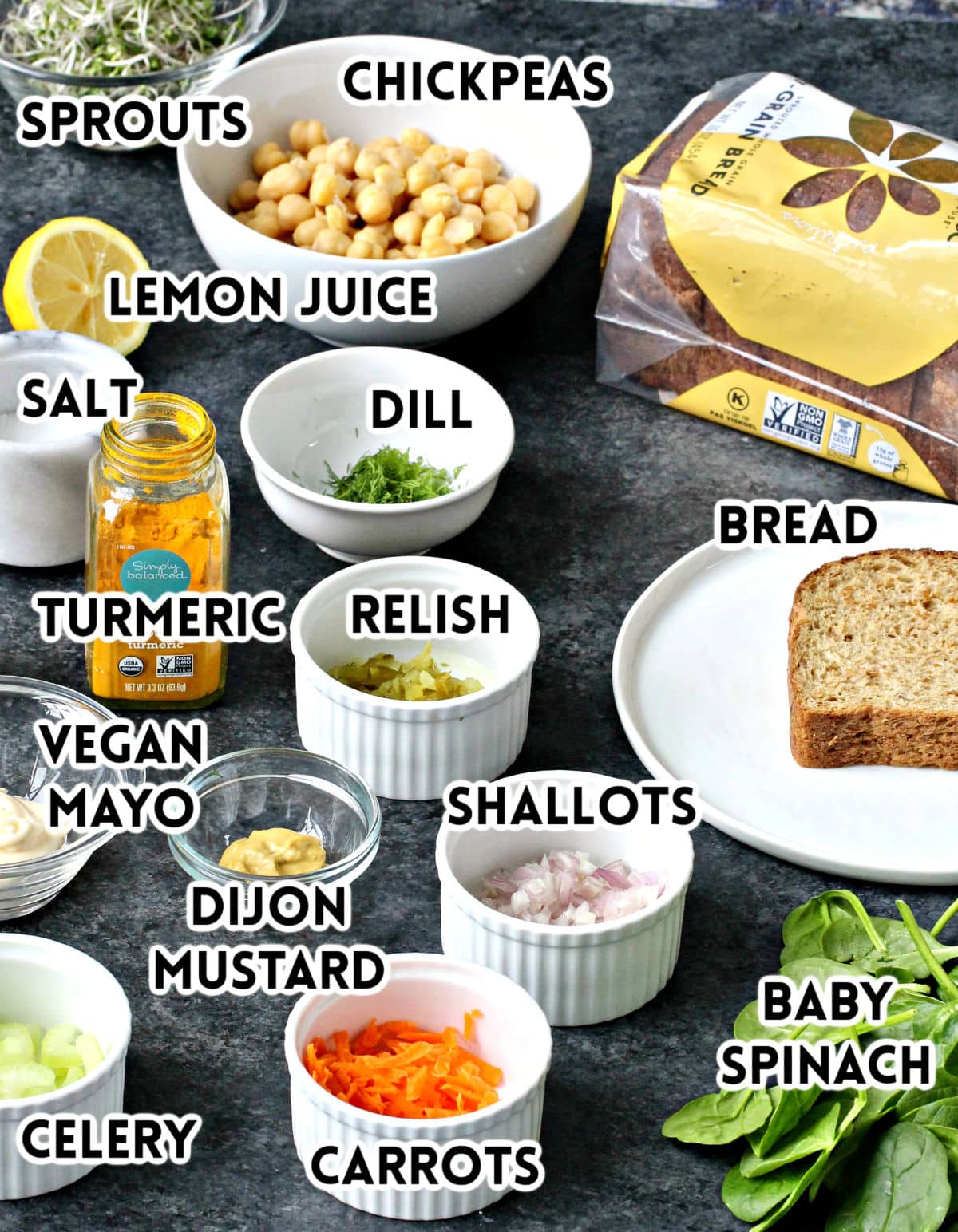 Ingredients for chickpea egg salad on a dark board. 