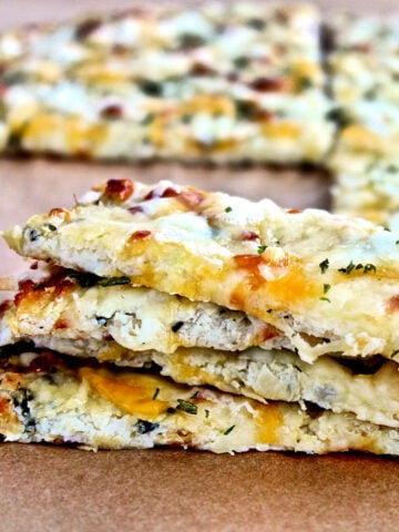 Cheesy cauliflower bread on parchment paper.