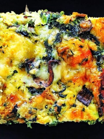 Spinach, Mushroom and Gruyere Strata on black plate