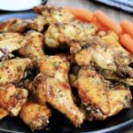 Pile of air fryer chicken wings on black plate