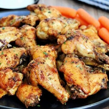 Pile of air fryer chicken wings on black plate