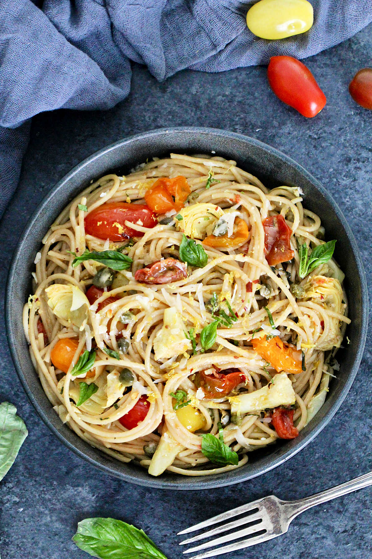 Overhead of Mediterranean pasta in a gray bowl.