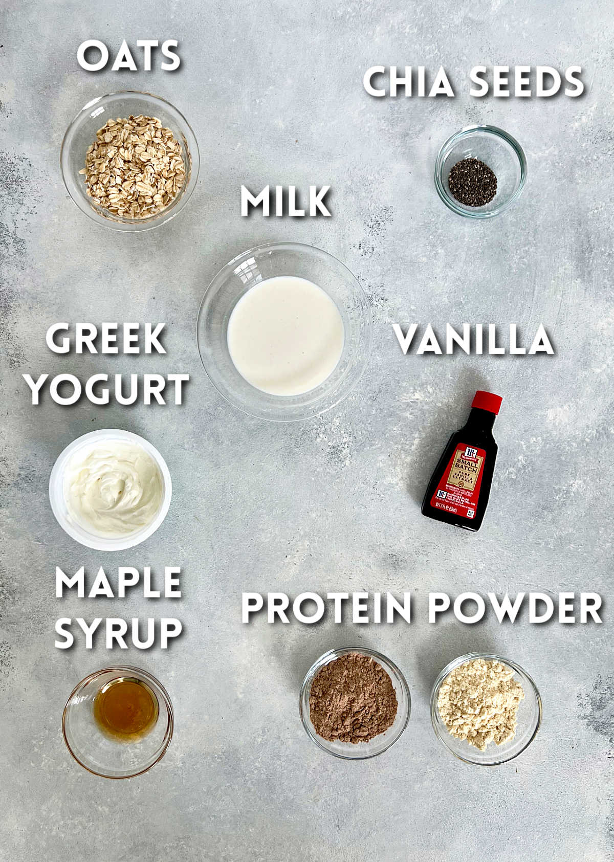 Ingredients for protein overnight oats on a light gray board.