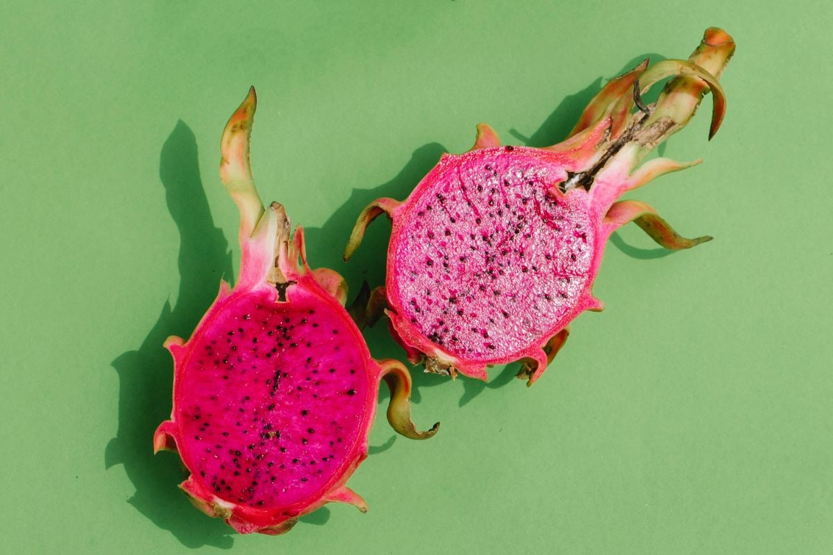 Pink dragon fruit on a green background.