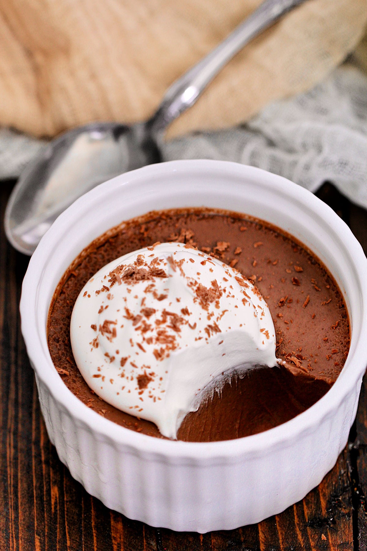 Chocolate Espresso Pot de Crème in a white ramekin with a silver spoon nearby.
