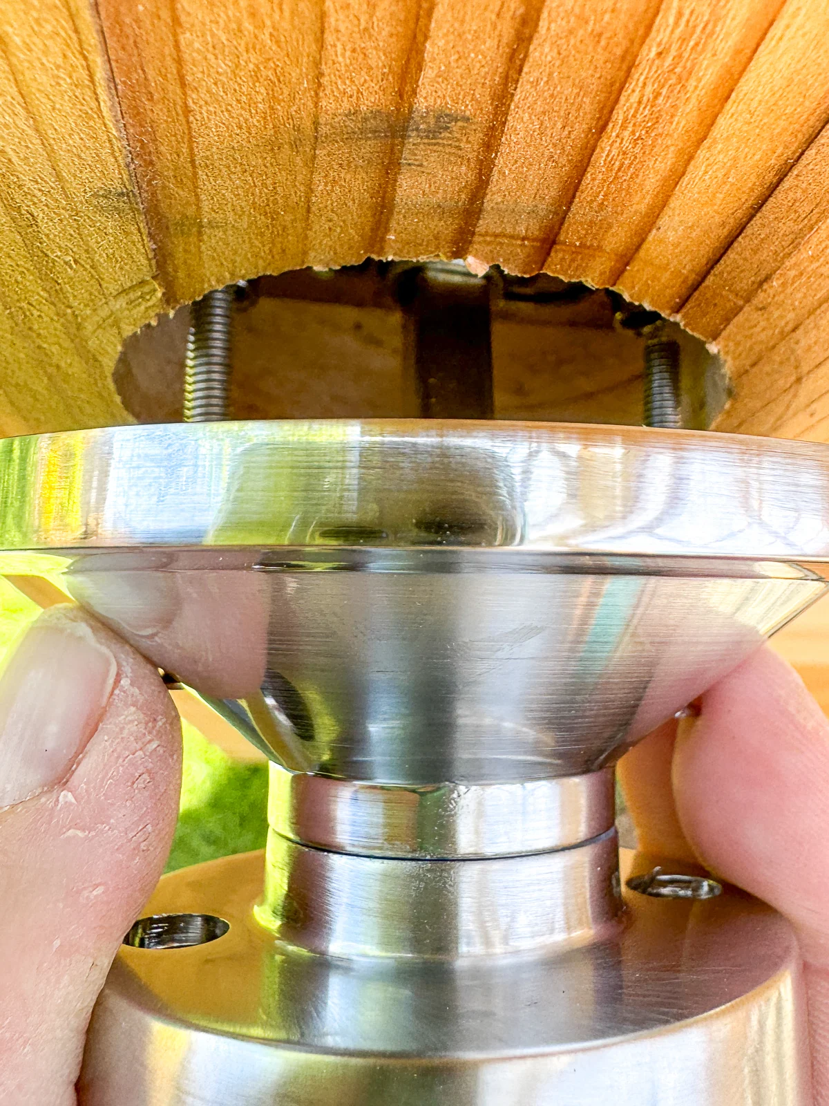 lining up the screws from the back of the door knob with the rods inside