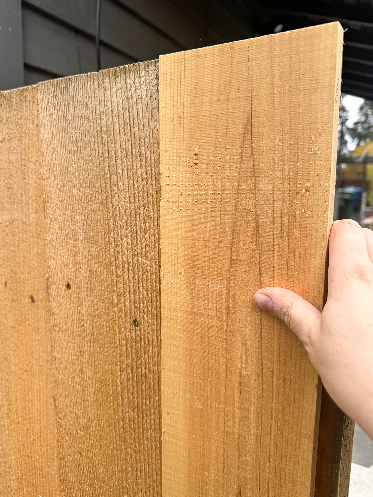 holding fence picket level before nailing into place
