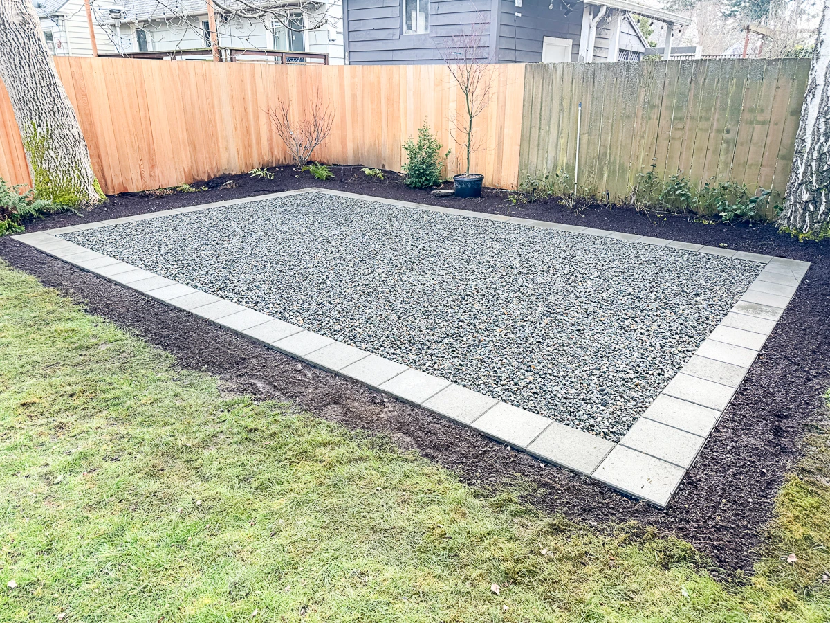 new and old fence panels with gravel patio in front