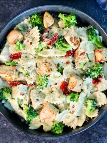 Pasta with Chicken and Creamy Cottage Cheese Sauce in a black bowl on a slate board.