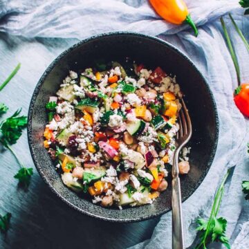 Mediterranean cucumber salad in a dark gray bowl.