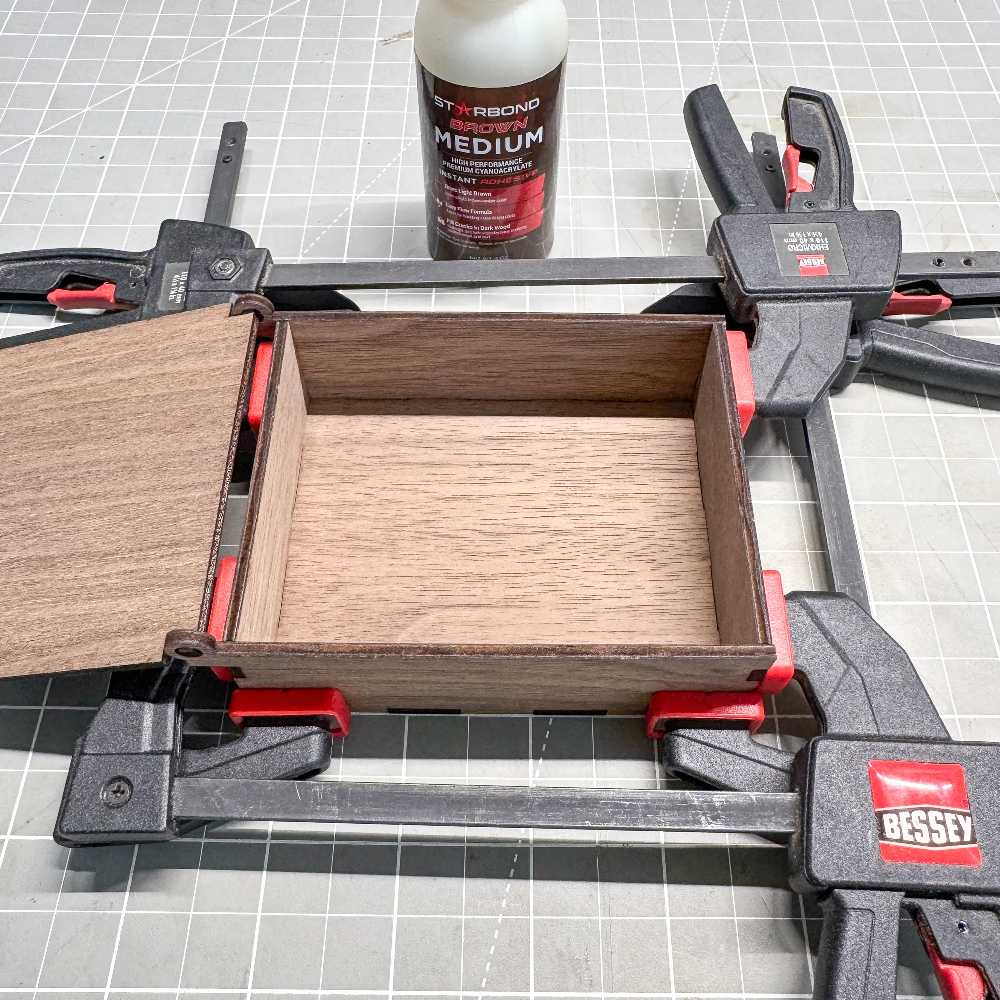 using small clamps to hold jewelry box parts together while glue dries